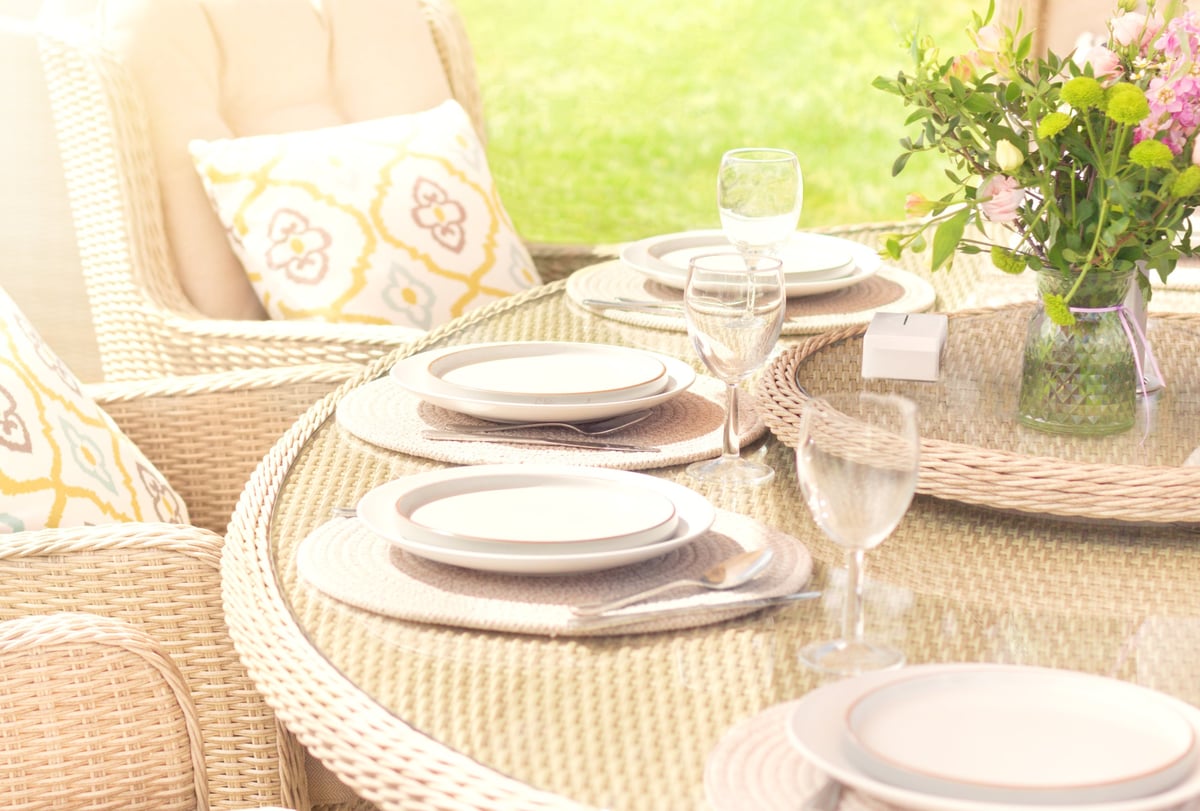 Bright outdoor summer dining experience with fresh flowers and elegant garden party setup