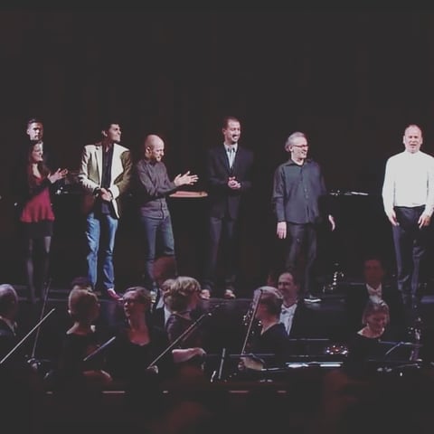 Orchestra musicians on stage in formal attire