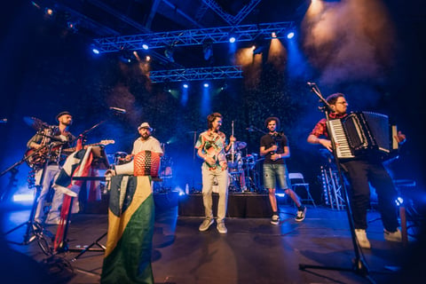 Band with cello, guitar and accordion on stage